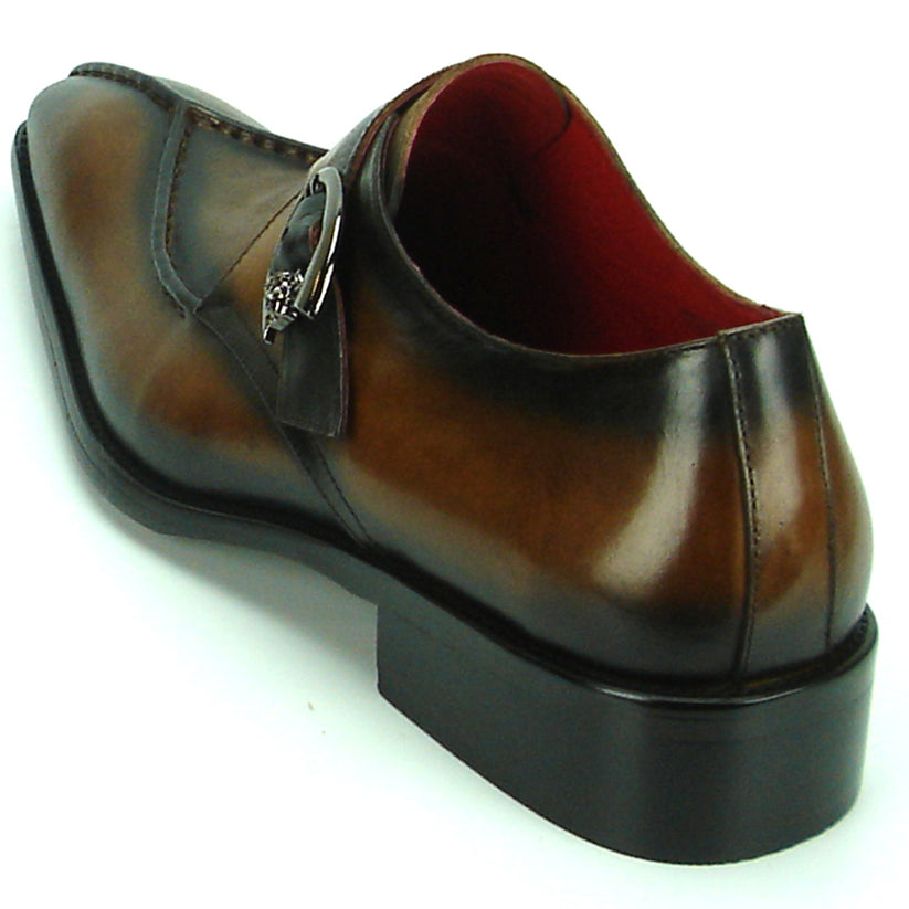 FI-8712 Coffee Encore by Fiesso—this handcrafted men’s dress shoe features rich brown leather, a pointed toe, black accent panels, a sleek side buckle, and a low heel. Displayed against a white background, it exemplifies the distinguished elegance of the Fiesso brand.