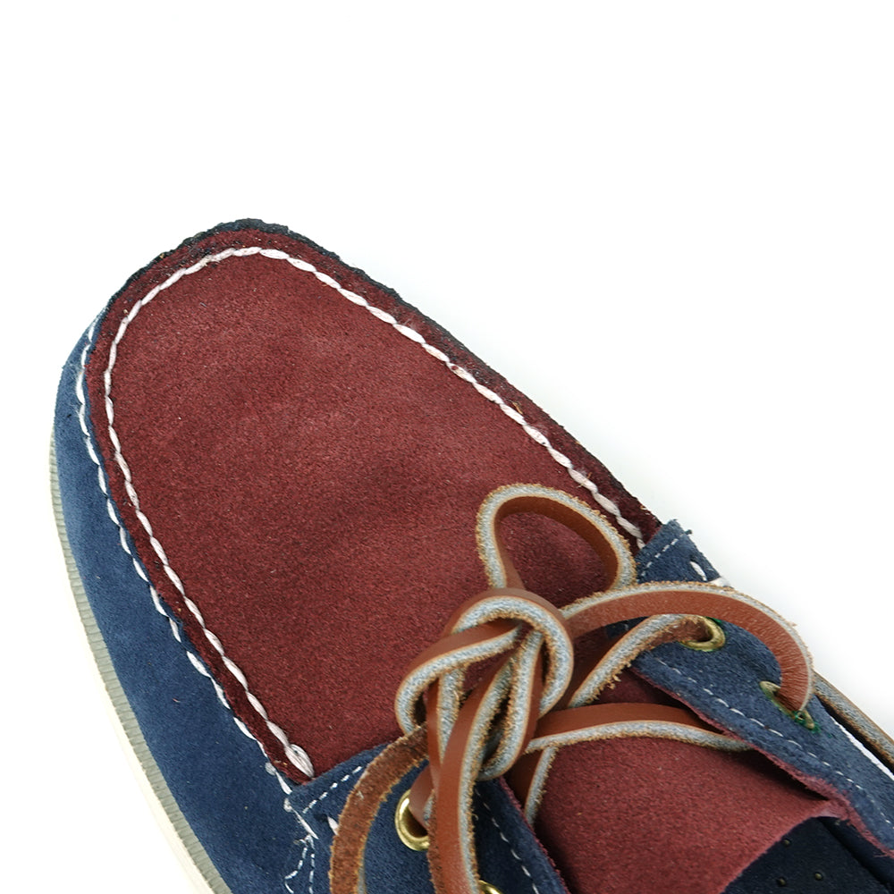 The FI-6512-S Navy Burgundy suede lace-up boat shoes by Fiesso feature white stitching, brown leather laces, and a white rubber sole—perfect for elevating men’s style with classic Fiesso flair.