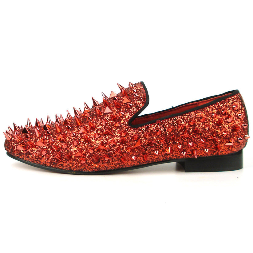 Introducing the FI-7239 Red Glitter Red Spikes by Fiesso, this striking slip-on shoe features a radiant red glitter finish and is adorned with an array of pointed metal spikes in various sizes. Crafted by Fiesso by Aurelio Garcia, this bold men’s fashion shoe redefines style boundaries with its handcrafted leather construction.
