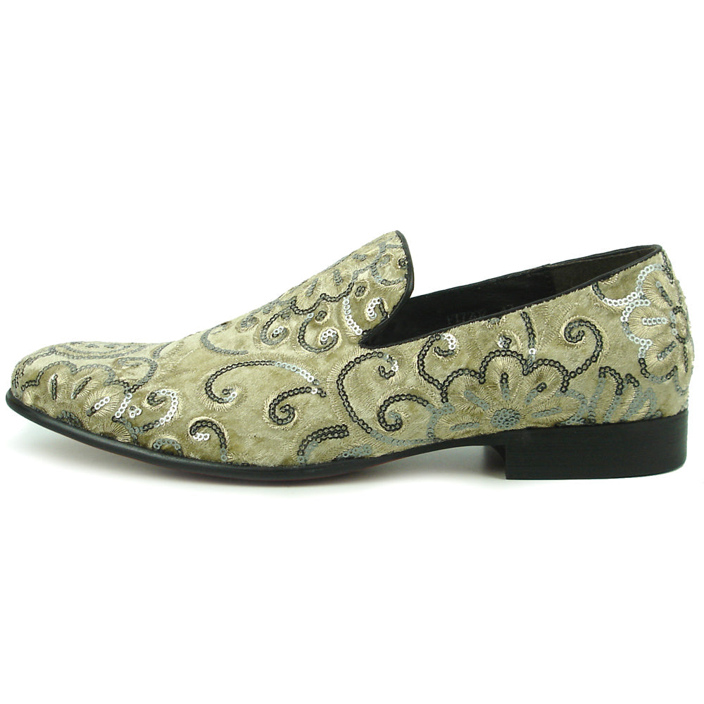 The FI-7363 Beige Slip-On Loafer by Fiesso features striking silver and black embroidered floral and swirl patterns with black trim—a standout men’s fashion piece from Fiesso.