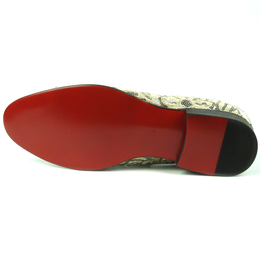 The FI-7363 Beige Slip-On Loafer by Fiesso features striking silver and black embroidered floral and swirl patterns with black trim—a standout men’s fashion piece from Fiesso.