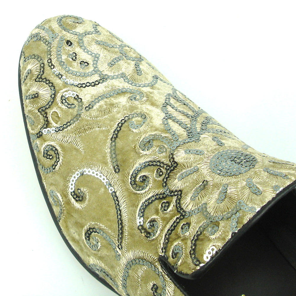 The FI-7363 Beige Slip-On Loafer by Fiesso features striking silver and black embroidered floral and swirl patterns with black trim—a standout men’s fashion piece from Fiesso.