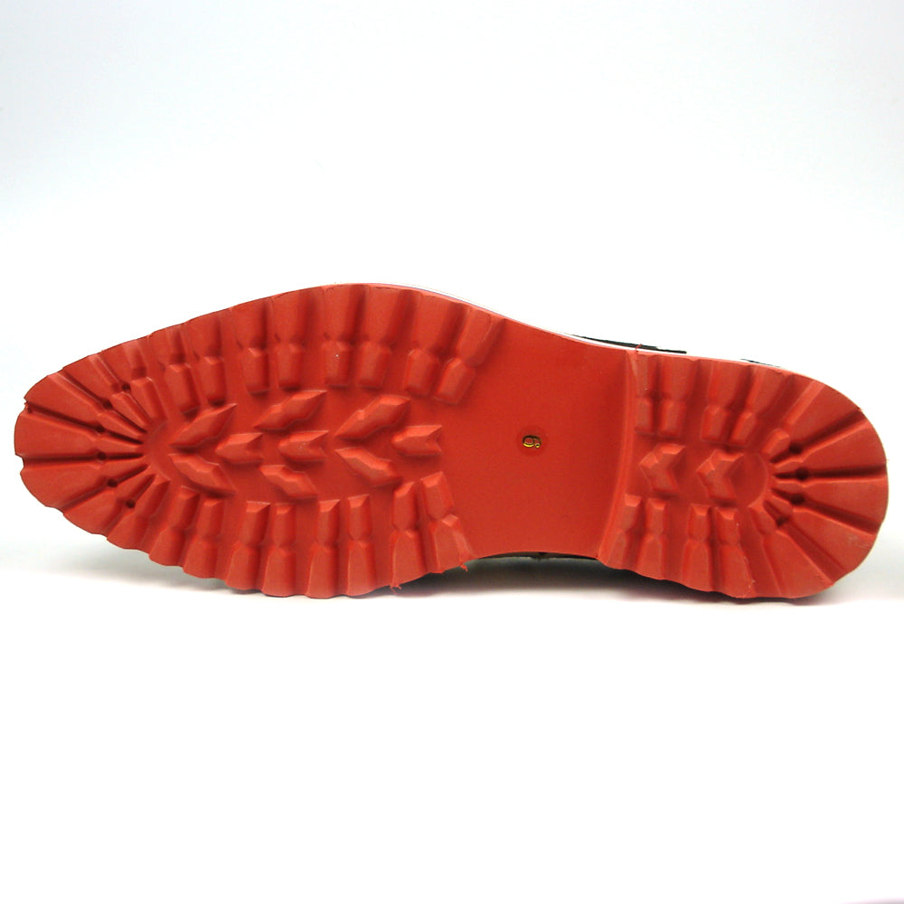 The FI-7455 Black White Cap Toe Spikes Slip On with Tassel by Fiesso features handcrafted leather, a red sole, blue trim, metal studs on the toe, and bold triangular metal accents—perfect for standout men’s fashion.