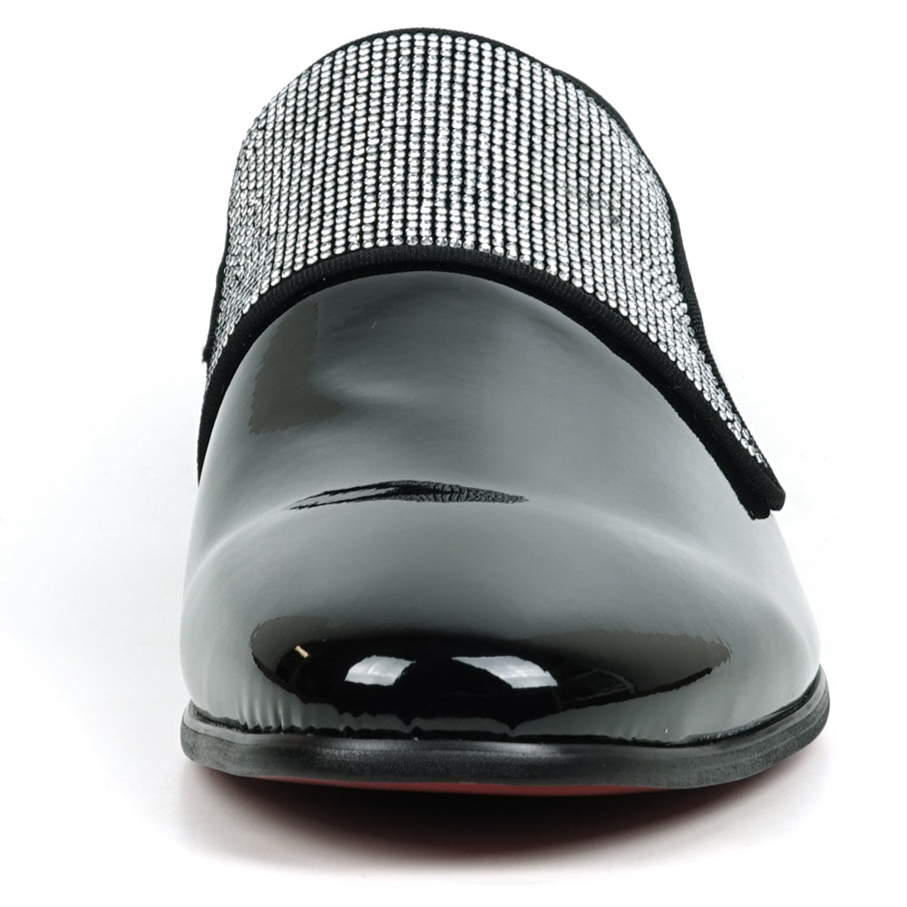 The FI-7549 Black Patent Rhinestones Slip on Loafer by Fiesso features a pointed toe and a flap with shiny silver studs, offering a bold update to the classic slip-on style.