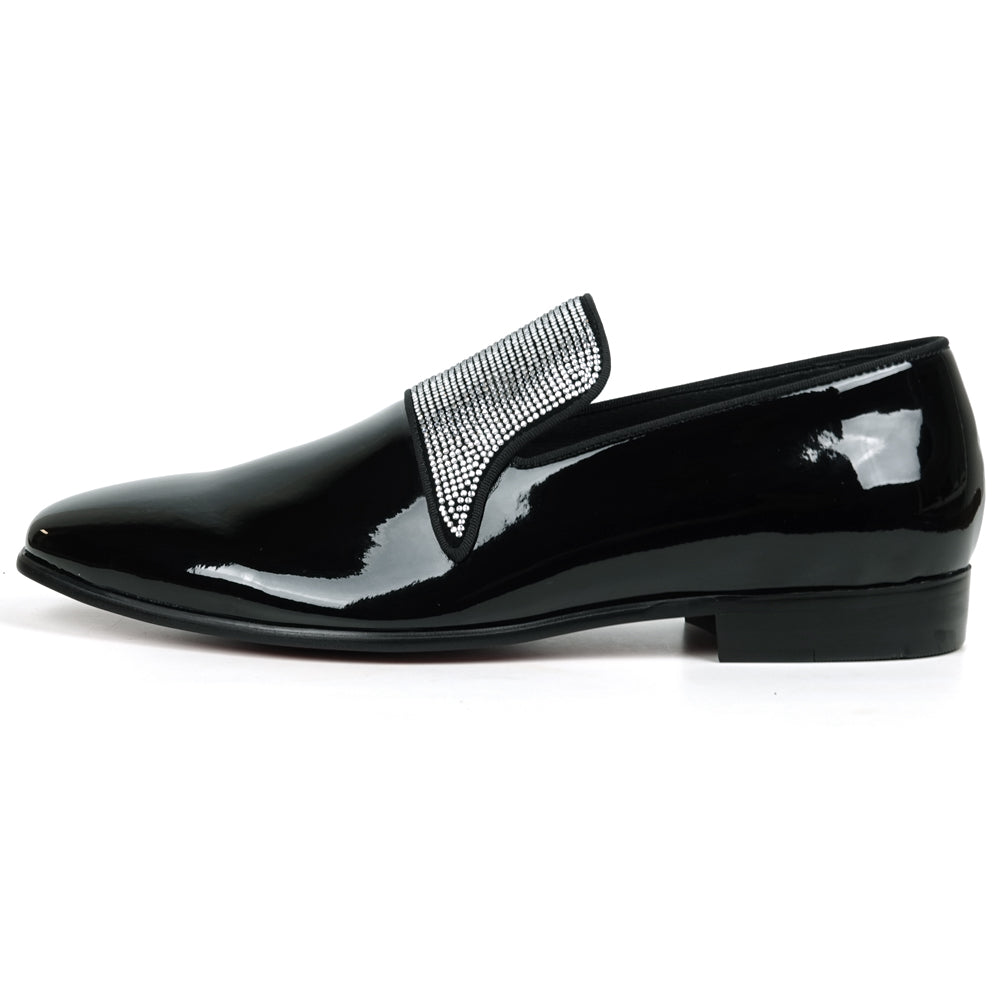 The FI-7549 Black Patent Rhinestones Slip on Loafer by Fiesso features a pointed toe and a flap with shiny silver studs, offering a bold update to the classic slip-on style.