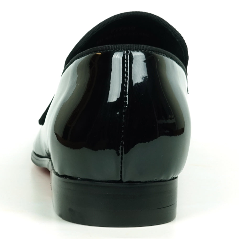 The FI-7549 Black Patent Rhinestones Slip on Loafer by Fiesso features a pointed toe and a flap with shiny silver studs, offering a bold update to the classic slip-on style.