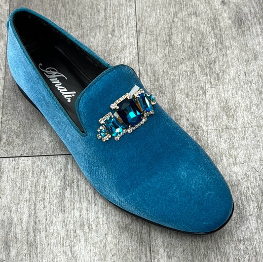 The Exclusive Formal Dress Shoe Teal TIAGO from UNIQUE DESIGN MENSWEAR sits elegantly on a gray tiled floor, featuring a decorative buckle with blue stones that highlights the exquisite craftsmanship of Italian genuine suede leather.