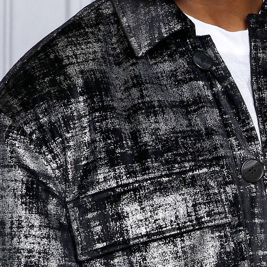 A man models the Insomnia's MANZINI GREECE Silver Metallic Fabric Button Down Coat, gazing to the side against an ornate white wall background.