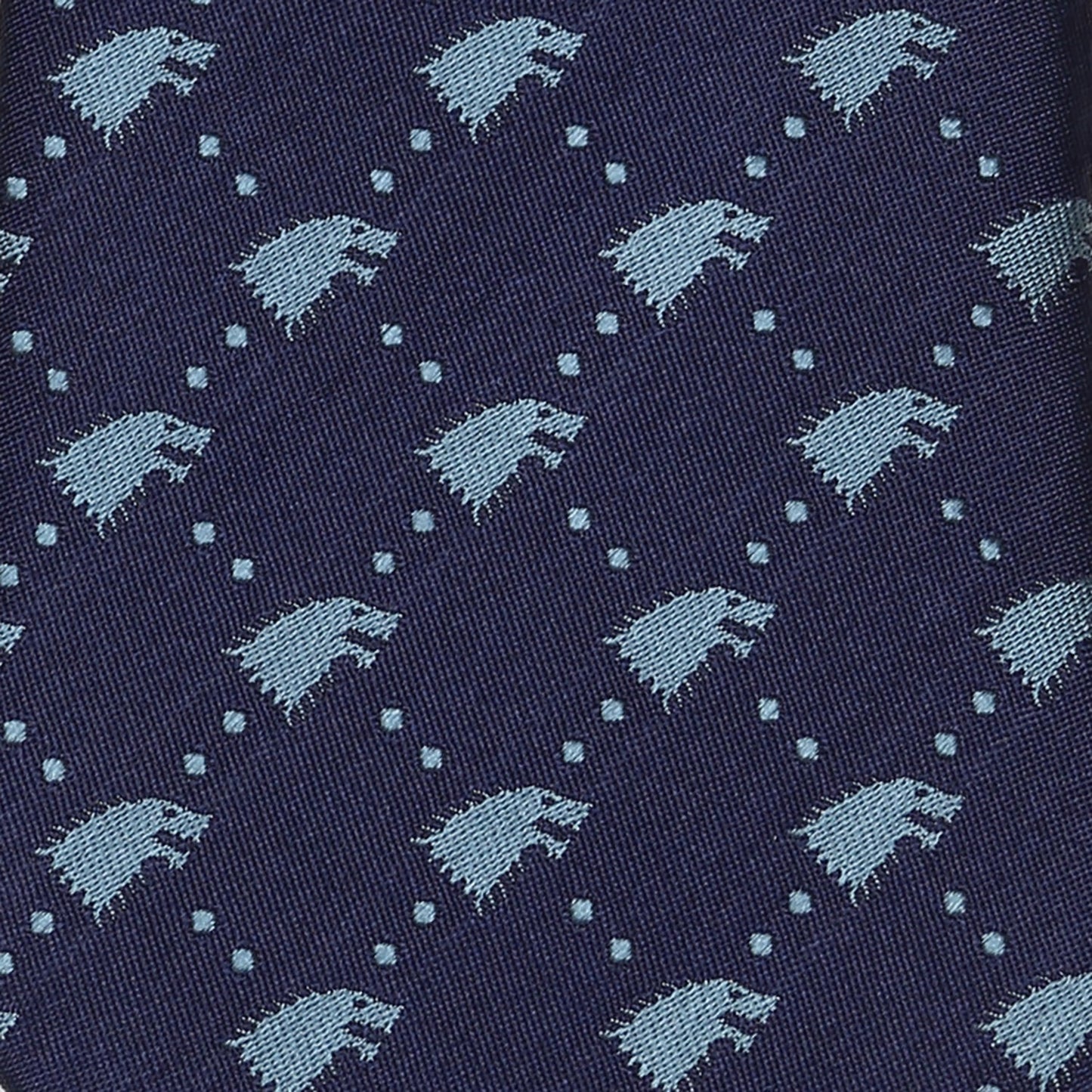 The Game of Thrones Stark Direwolf Men's Tie by Cufflinks.com is a rolled-up navy blue silk tie featuring a repeating pattern of small, light blue direwolves.