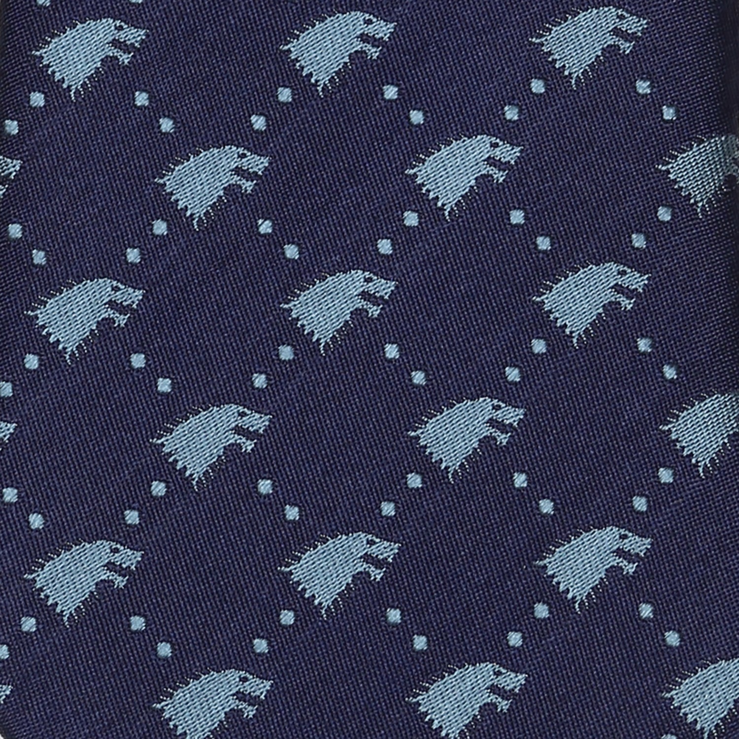 The Game of Thrones Stark Direwolf Men's Tie by Cufflinks.com is a rolled-up navy blue silk tie featuring a repeating pattern of small, light blue direwolves.