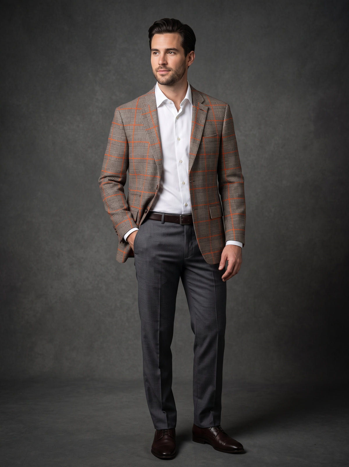 The Inserch Wool Blend Glenn Check Blazer BL002-25 Brown (FINAL SALE, SIZE S ONLY) features an orange lining and orange windowpane pattern, shown on a hanger against a wooden background.