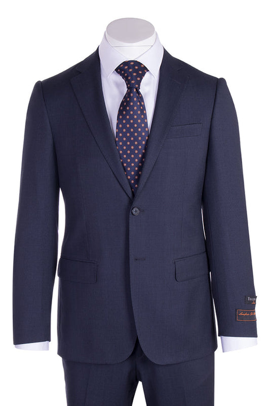 The Tiglio Luxe Novello Blue Birdseye Pure Wool Men’s Suit IDM7018/9 is styled with a white dress shirt and a navy tie with orange polka dots, displayed on a mannequin.