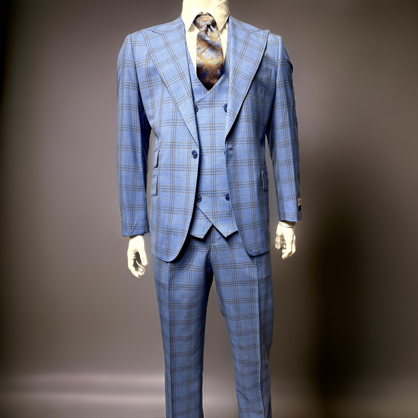 A mannequin dressed in a Tiglio Rosso Orvietto Blue/Tan Windowpane TL6371 suit, featuring a three-piece design made from 100% wool with a patterned tie, set against a neutral background.