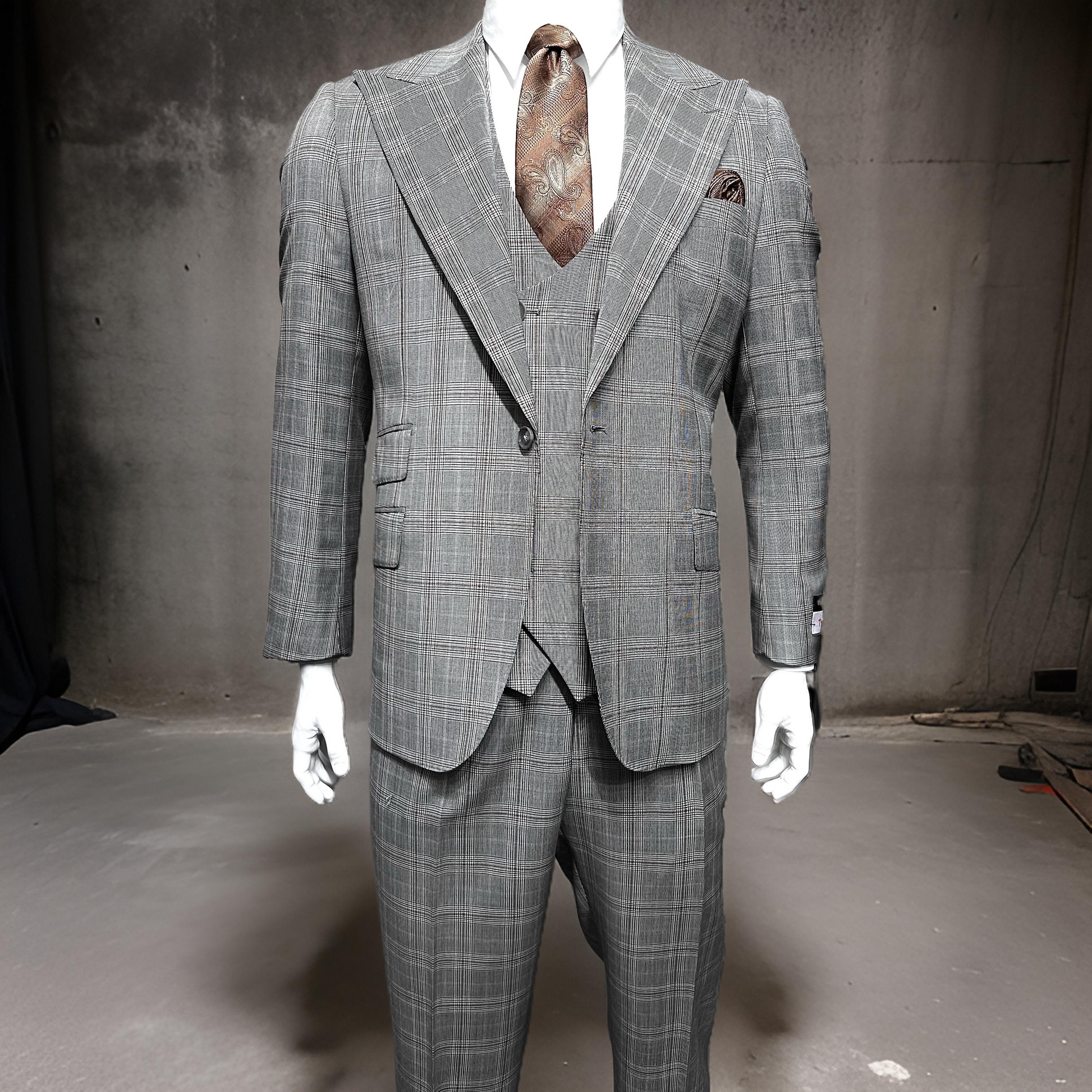 A Tiglio Rosso Orvietto Taupe/Brown Plaid TL5203 suit is shown on a mannequin with a brown patterned tie against a plain, industrial-style background.