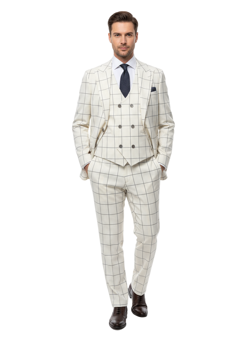 A man exudes confidence in the Tiglio Luxe Off White with Brown Windowpane Prosecco TL4113, a modern fit pure wool suit and vest by Tiglio Luxe. He pairs the suit with a crisp white shirt, a navy blue tie adorned with white dots, and dark brown dress shoes. Standing with hands in his pockets against a white background, he exemplifies the sophistication of Italian menswear.
