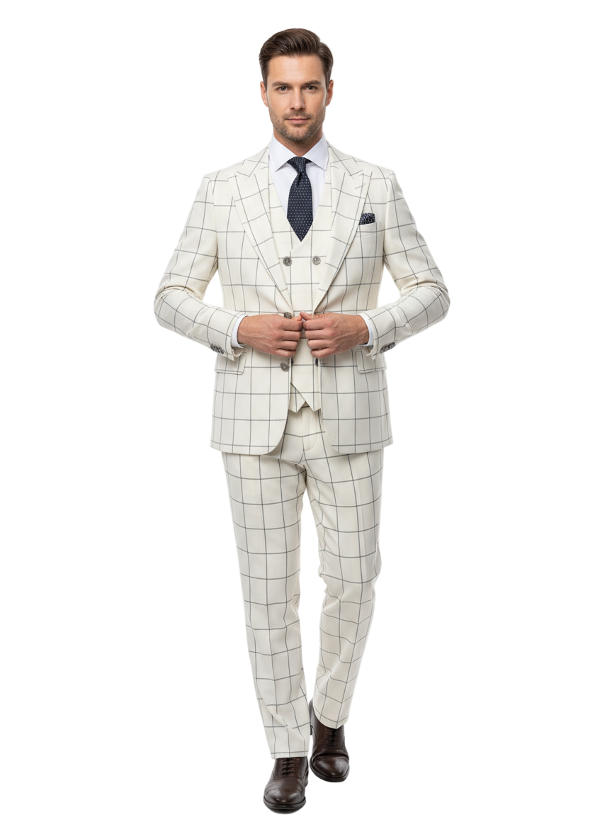 A man exudes confidence in the Tiglio Luxe Off White with Brown Windowpane Prosecco TL4113, a modern fit pure wool suit and vest by Tiglio Luxe. He pairs the suit with a crisp white shirt, a navy blue tie adorned with white dots, and dark brown dress shoes. Standing with hands in his pockets against a white background, he exemplifies the sophistication of Italian menswear.