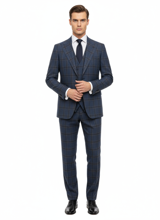 A man wearing the Tiglio Luxe Denim Blue with Windowpanes Prosecco, Modern Fit Pure Wool Suit & Vest TL8101 by Tiglio Luxe, paired with a white dress shirt, navy tie, and black shoes, stands against a plain white background.