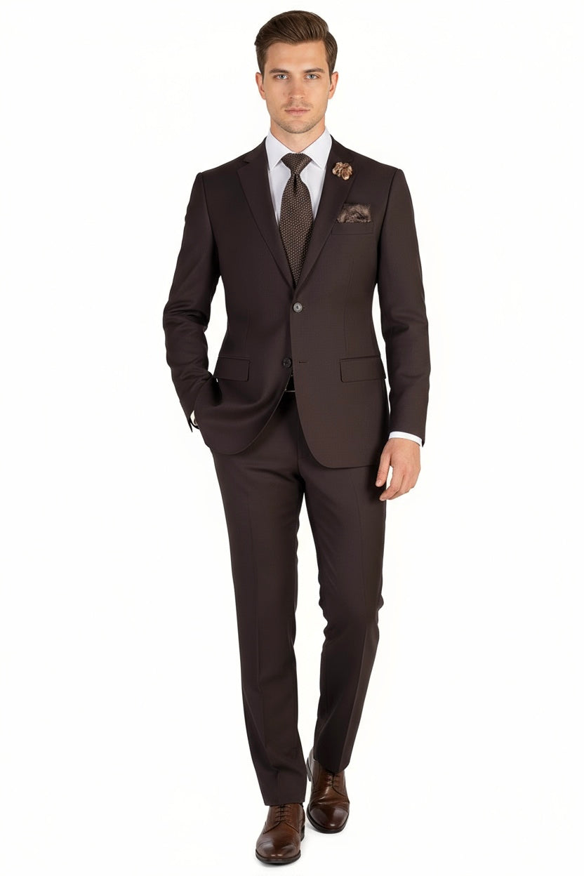 A man stands facing forward against a plain white background, wearing the Tiglio Luxe Brown Porto Slim Fit, Pure Wool Suit (TIG1003) paired with a white dress shirt, brown tie, pocket square, and brown dress shoes—showcasing the elegance of luxury men’s fashion by Tiglio Luxe.