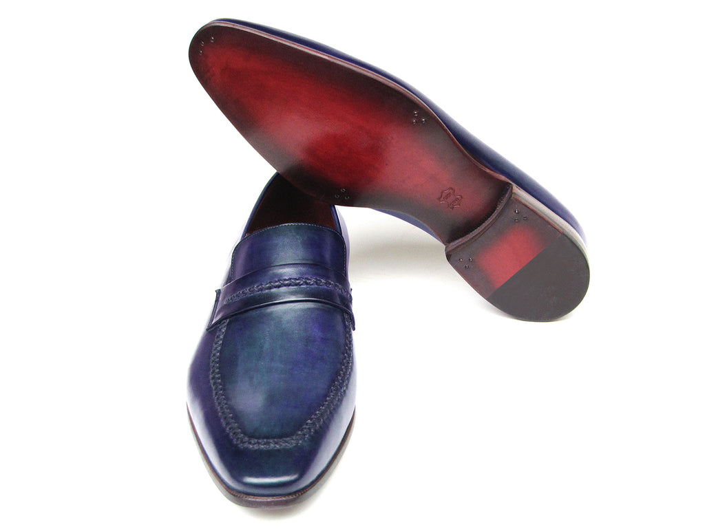 A pair of Paul Parkman Loafer Shoes Navy - 068-BLU, crafted from Italian calfskin with a red interior lining and brown soles, positioned one leaning on the other.