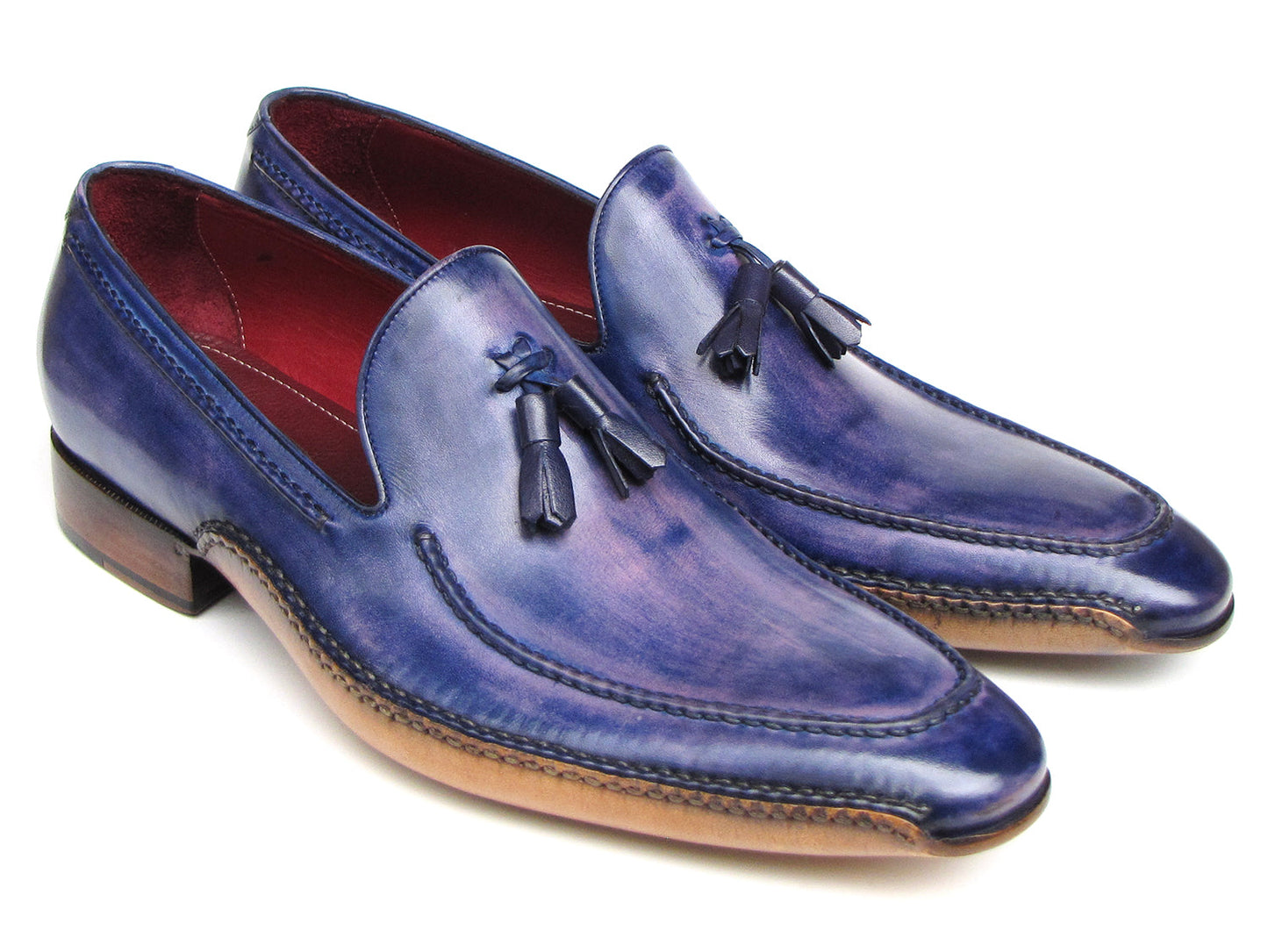 The Paul Parkman Side Handsewn Tassel Loafer Blue & Purple (082-BLU-PURP) pairs hand-painted blue and purple leather with a red interior lining and tan soles, offering stylish slip-on elegance for men.