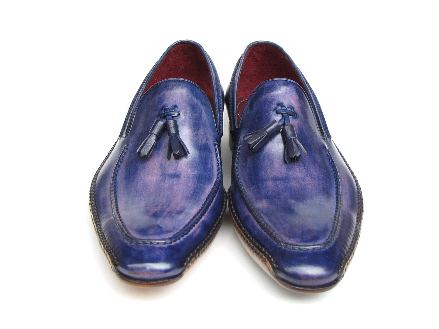 The Paul Parkman Side Handsewn Tassel Loafer Blue & Purple (082-BLU-PURP) pairs hand-painted blue and purple leather with a red interior lining and tan soles, offering stylish slip-on elegance for men.