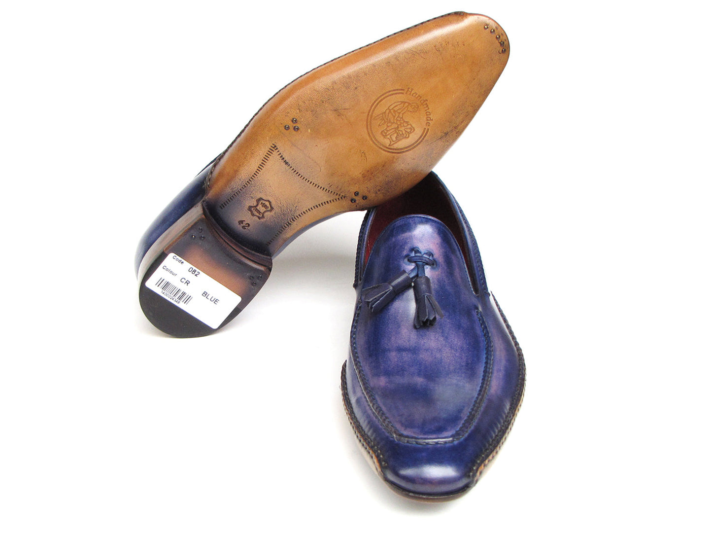 The Paul Parkman Side Handsewn Tassel Loafer Blue & Purple (082-BLU-PURP) pairs hand-painted blue and purple leather with a red interior lining and tan soles, offering stylish slip-on elegance for men.