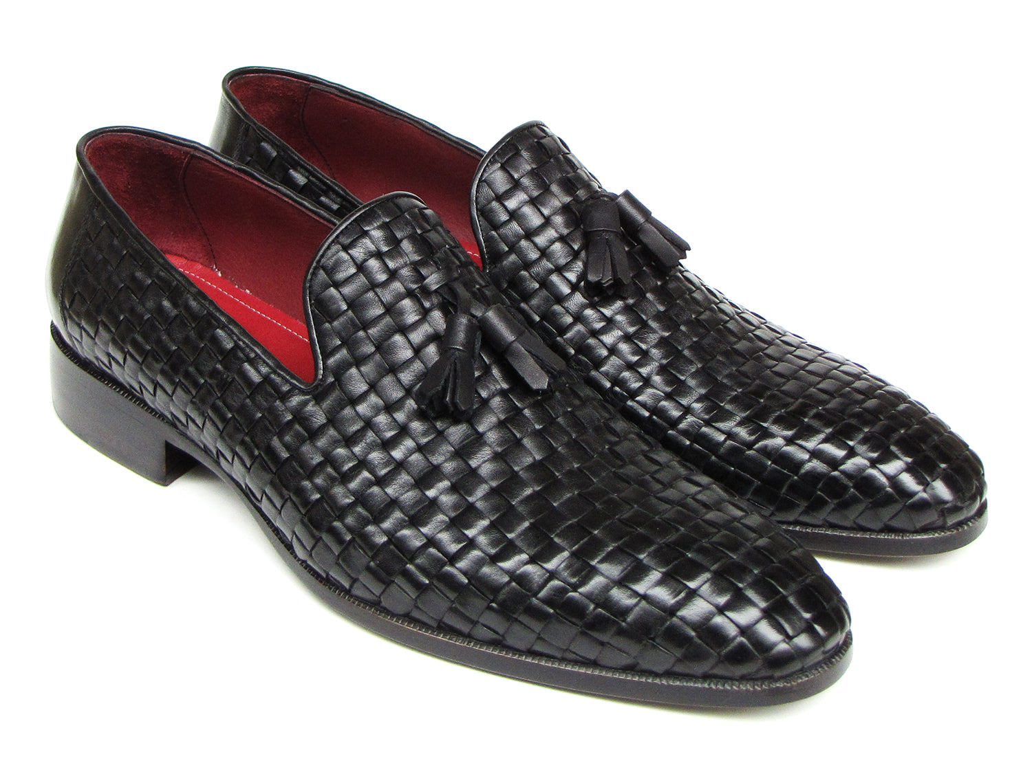The Paul Parkman Tassel Loafer Black Woven Leather - 085-BLK features black woven leather, red interior lining, and wooden soles—one shoe upright and one on its side to display the elegant men’s footwear from Paul Parkman.