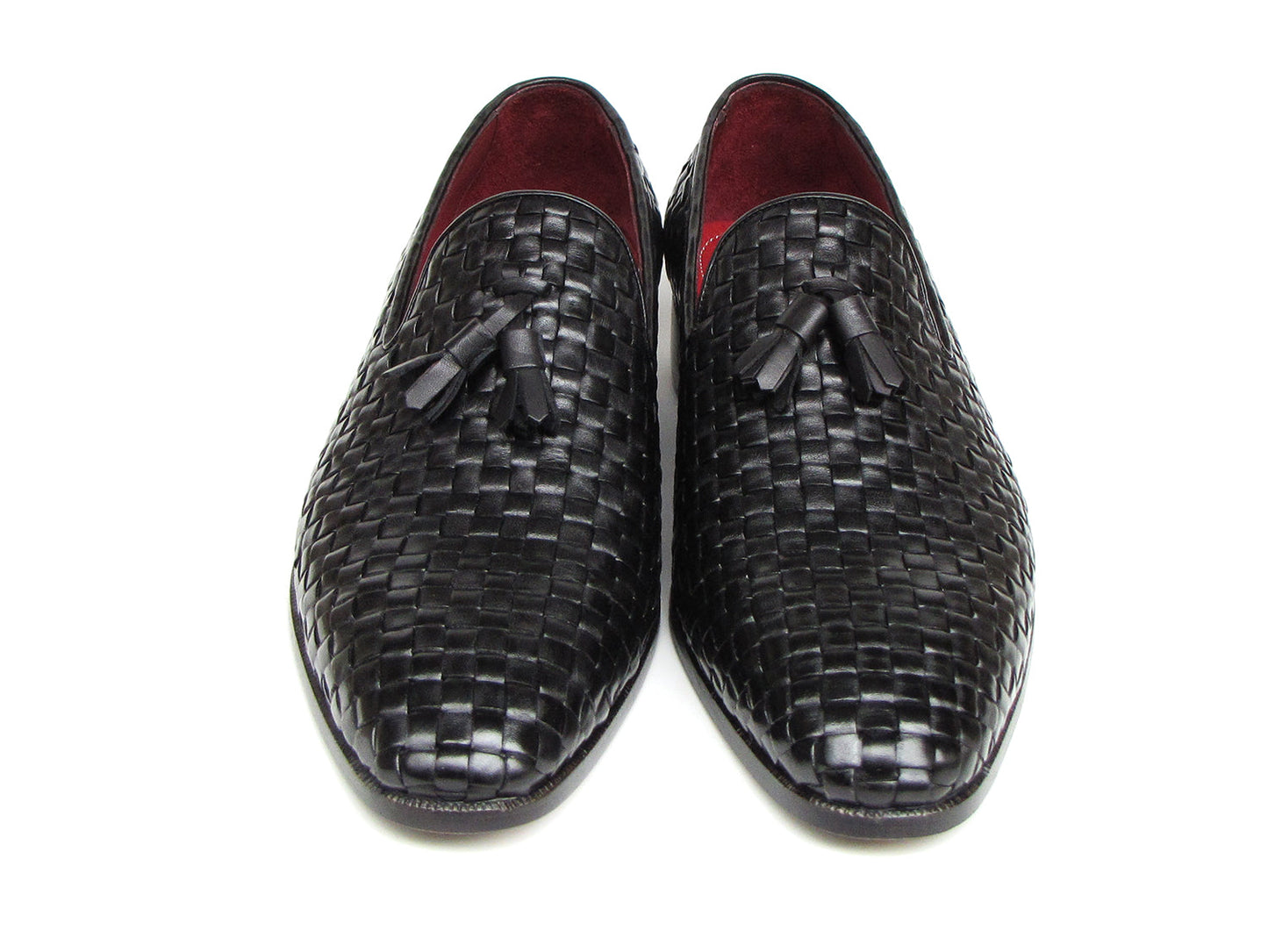 The Paul Parkman Tassel Loafer Black Woven Leather - 085-BLK features black woven leather, red interior lining, and wooden soles—one shoe upright and one on its side to display the elegant men’s footwear from Paul Parkman.