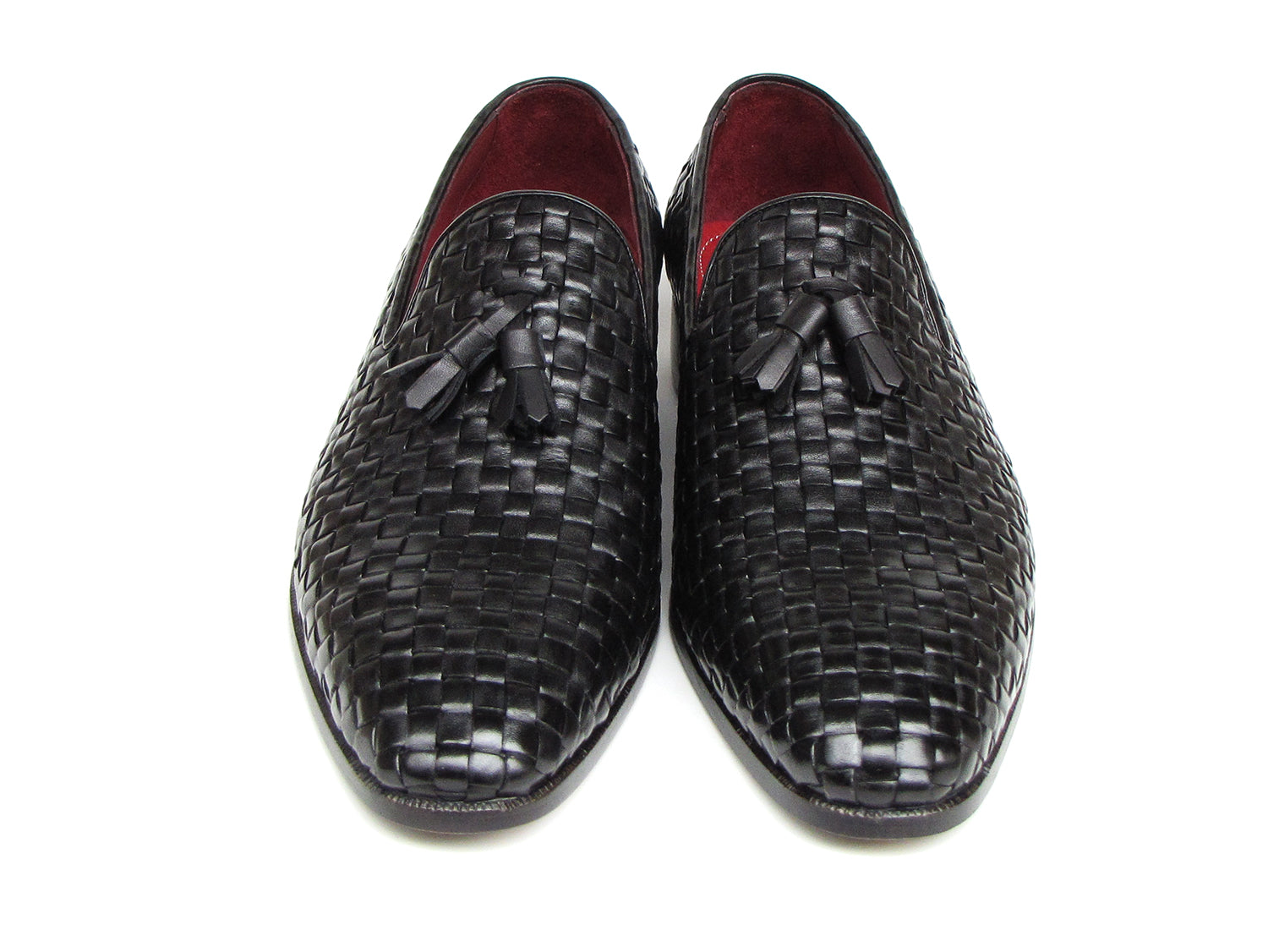 The Paul Parkman Tassel Loafer Black Woven Leather - 085-BLK features black woven leather, red interior lining, and wooden soles—one shoe upright and one on its side to display the elegant men’s footwear from Paul Parkman.