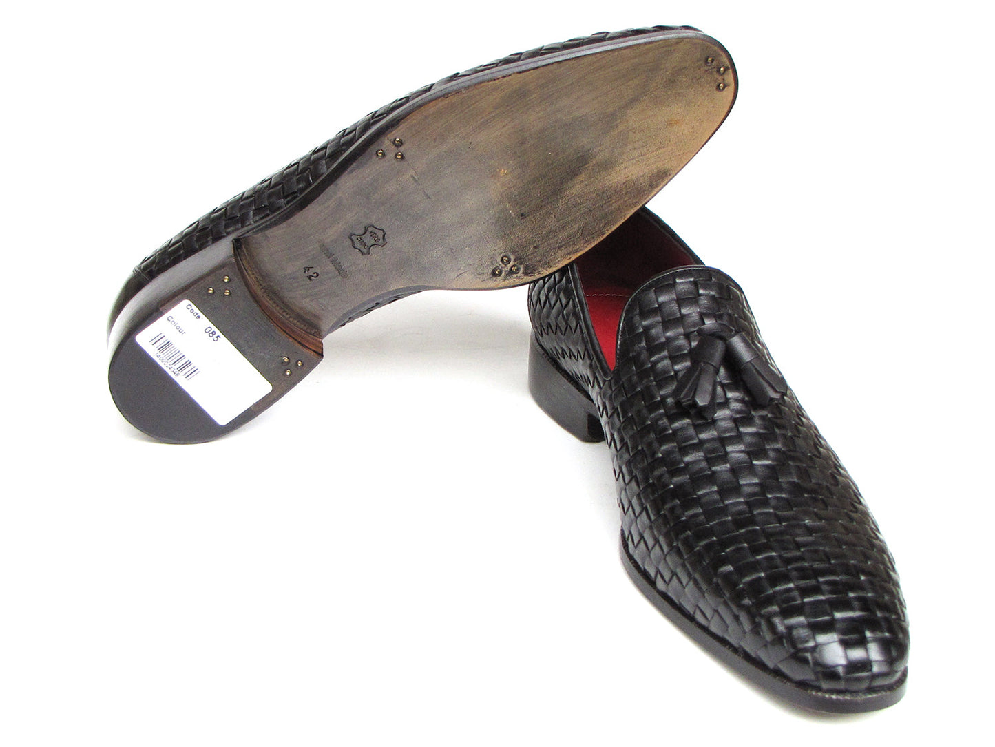 The Paul Parkman Tassel Loafer Black Woven Leather - 085-BLK features black woven leather, red interior lining, and wooden soles—one shoe upright and one on its side to display the elegant men’s footwear from Paul Parkman.