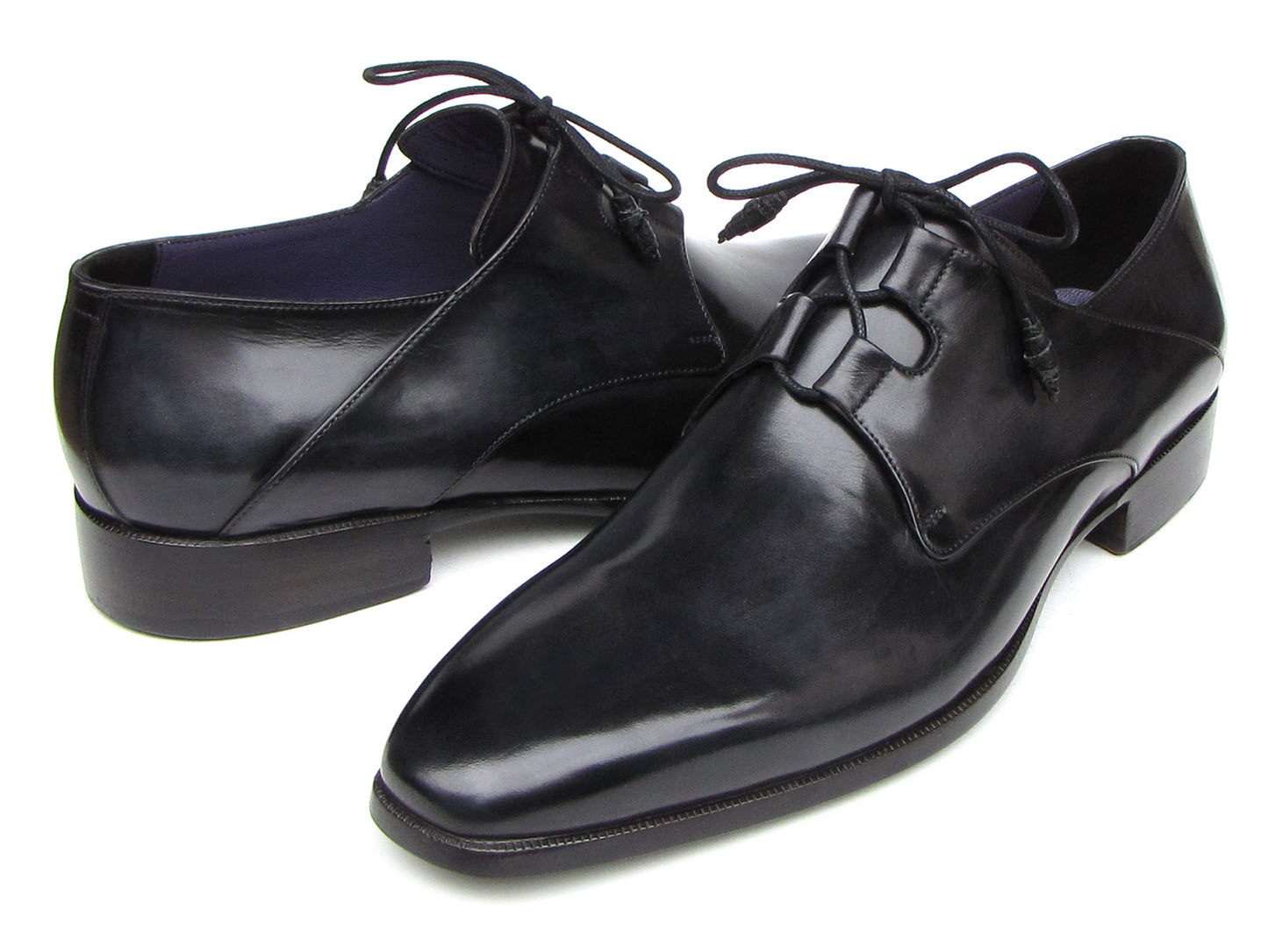 A pair of Paul Parkman Ghillie Lacing Plain Toe Black Shoes (076-BLK)—one shoe stands upright while the other rests on its side.