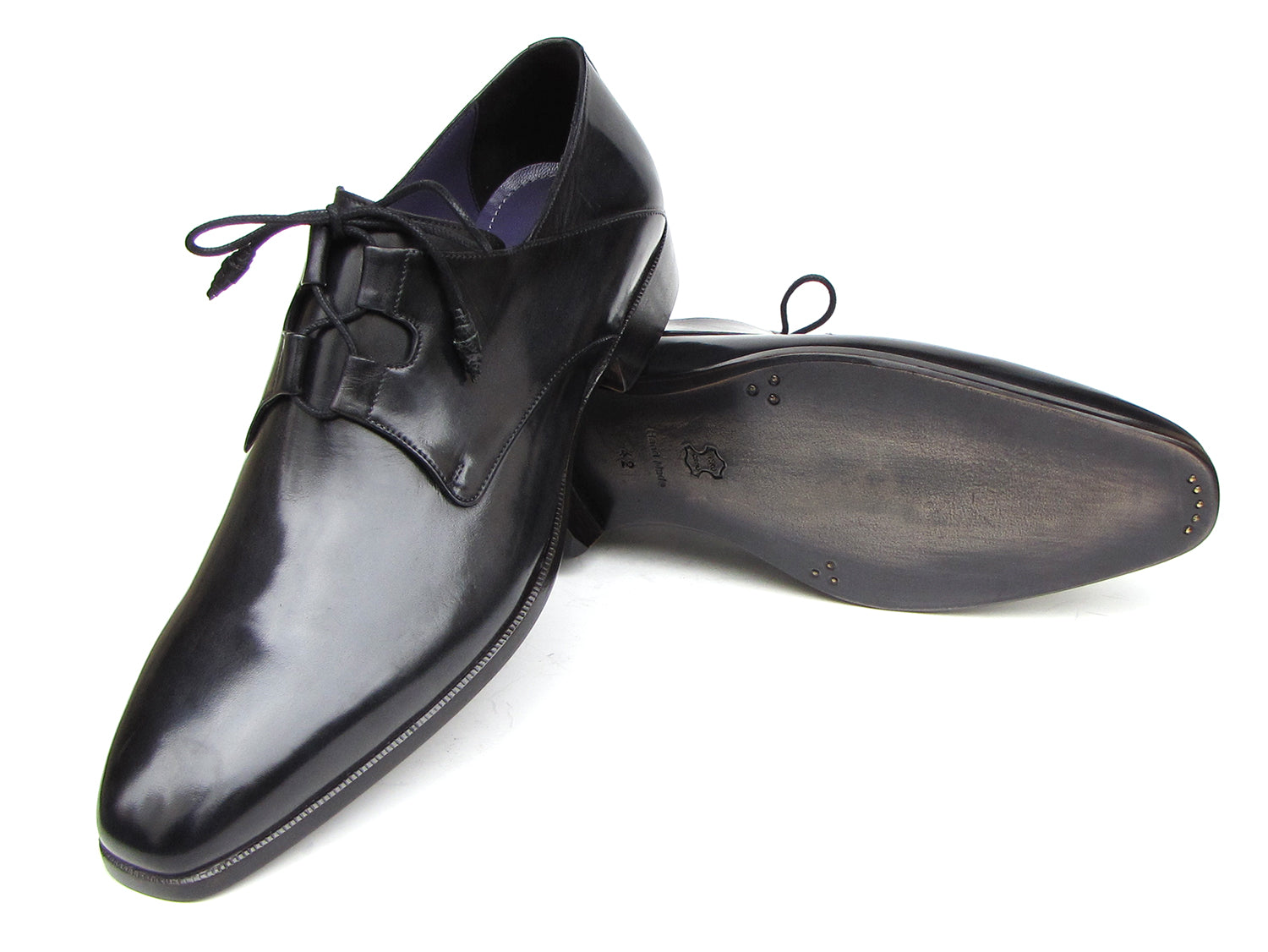A pair of Paul Parkman Ghillie Lacing Plain Toe Black Shoes (076-BLK)—one shoe stands upright while the other rests on its side.