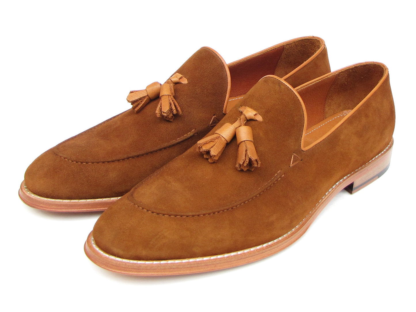 Paul Parkman Tassel Loafers Tobacco Suede - 087-TAB by Paul Parkman: one loafer stands upright while the other lies on its side, showing the leather sole.