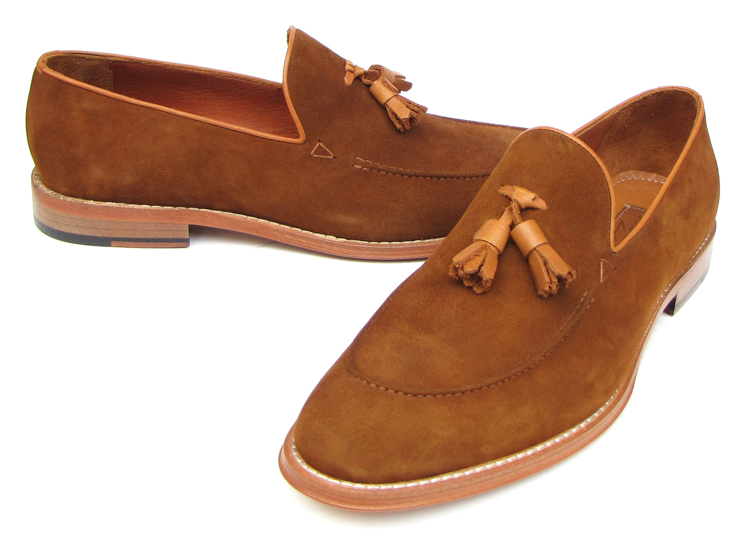 Paul Parkman Tassel Loafers Tobacco Suede - 087-TAB by Paul Parkman: one loafer stands upright while the other lies on its side, showing the leather sole.