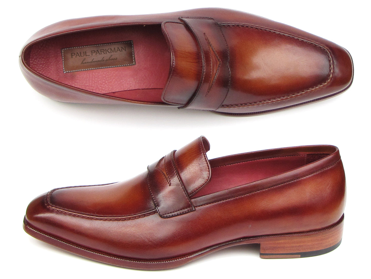 The Paul Parkman Penny Loafer Tobacco & Bordeaux Hand-Painted Shoes (067-BRD) for men feature brown leather, visible stitching, a wooden heel, and a branded insole, combining classic style with expert craftsmanship.
