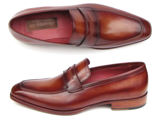 The Paul Parkman Penny Loafer Tobacco & Bordeaux Hand-Painted Shoes (067-BRD) for men feature brown leather, visible stitching, a wooden heel, and a branded insole, combining classic style with expert craftsmanship.