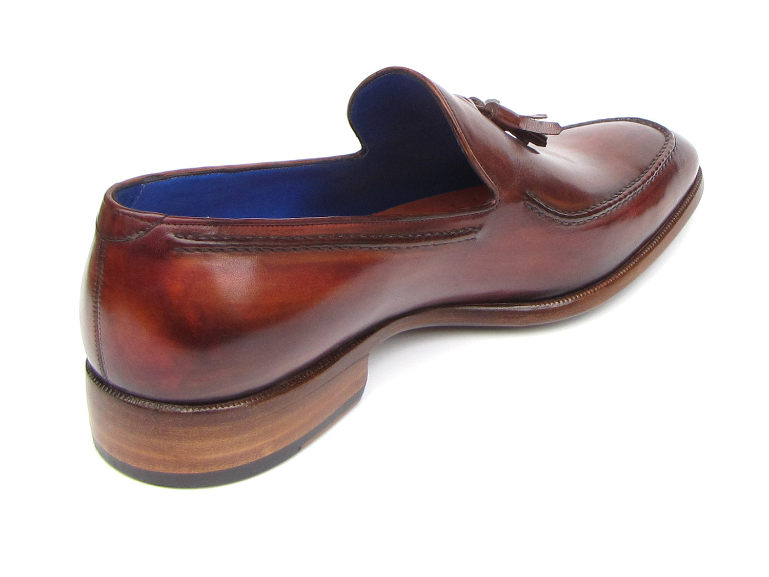 The Paul Parkman Tassel Loafer Brown - 073-BRD features hand-painted brown Italian calfskin, blue inner lining, wooden soles, and the "Paul Parkman handmade shoes" label for timeless elegance.