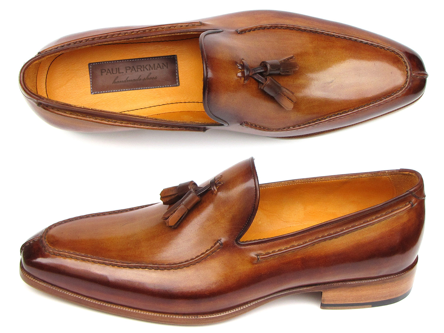 The Paul Parkman Tassel Loafer Camel & Brown Hand-Painted - 083-CML features a polished finish, low heel, and elegant hand-painted leather—shown from a slightly angled side view—making it a sophisticated men's shoe choice.
