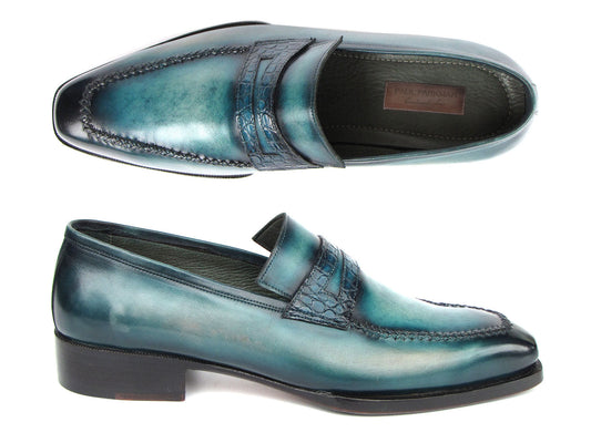 Introducing the Paul Parkman Turquoise Patina Handmade Loafers 6944-TRQ, a stunning pair of teal leather loafers from the renowned brand Paul Parkman. These loafers feature black soles and a stitched design with a decorative strap across the front. Expertly made-to-order, they boast hand-painted leather and Goodyear welted construction for timeless elegance and durability.