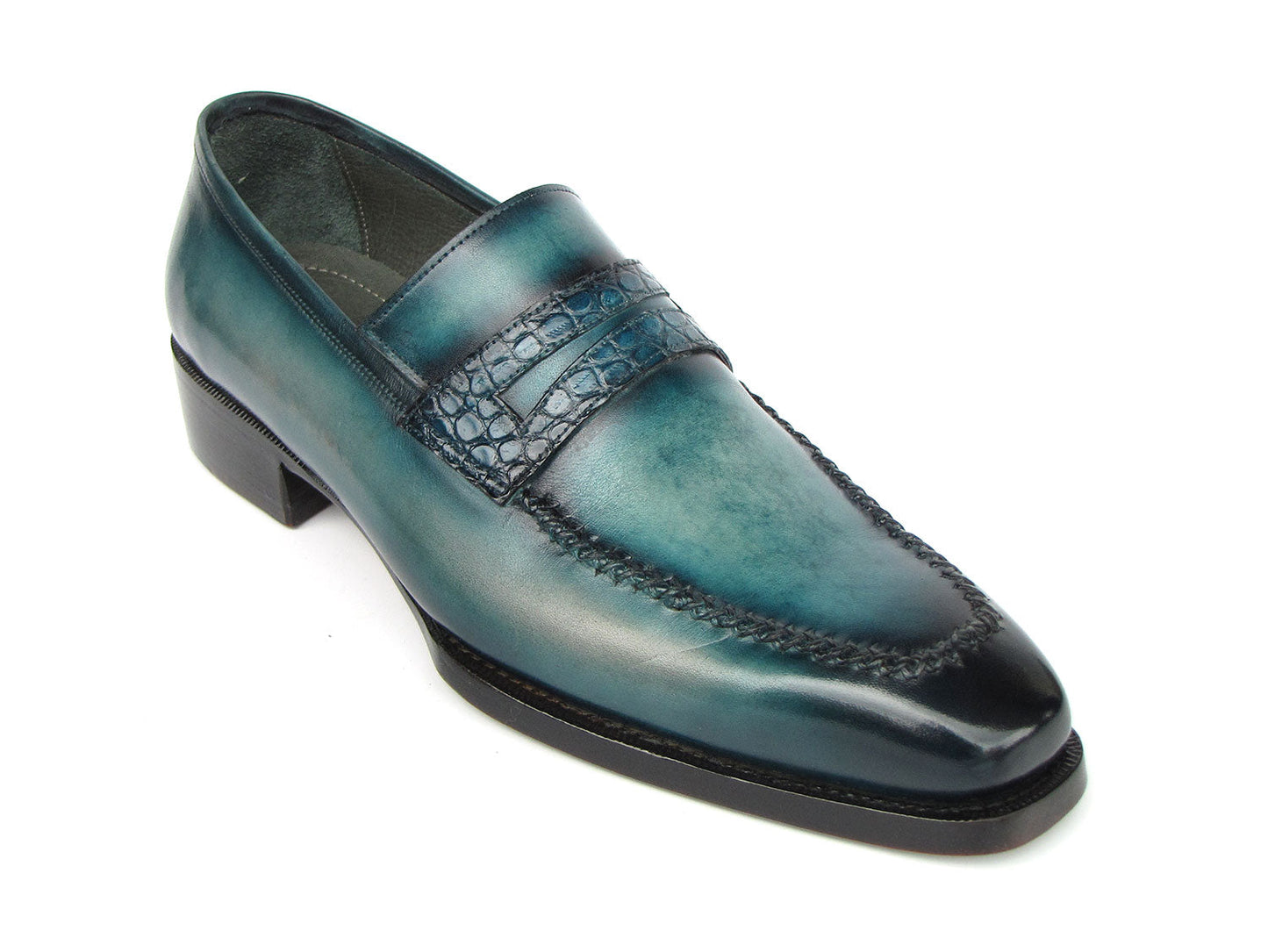 Introducing the Paul Parkman Turquoise Patina Handmade Loafers 6944-TRQ, a stunning pair of teal leather loafers from the renowned brand Paul Parkman. These loafers feature black soles and a stitched design with a decorative strap across the front. Expertly made-to-order, they boast hand-painted leather and Goodyear welted construction for timeless elegance and durability.
