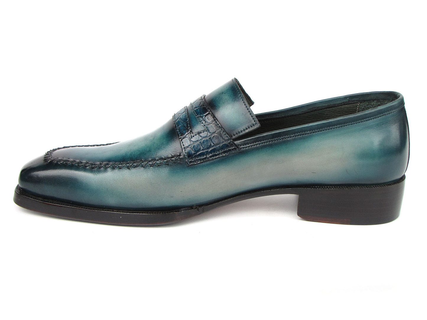 Introducing the Paul Parkman Turquoise Patina Handmade Loafers 6944-TRQ, a stunning pair of teal leather loafers from the renowned brand Paul Parkman. These loafers feature black soles and a stitched design with a decorative strap across the front. Expertly made-to-order, they boast hand-painted leather and Goodyear welted construction for timeless elegance and durability.