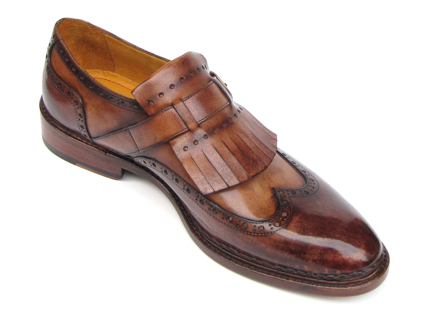 The Paul Parkman Wingtip Monkstraps Brown - 060-BRW features brown leather, decorative perforations, and a fringed kiltie detail. Handcrafted with Goodyear welted construction, this men's dress shoe is shown at a slight angle.