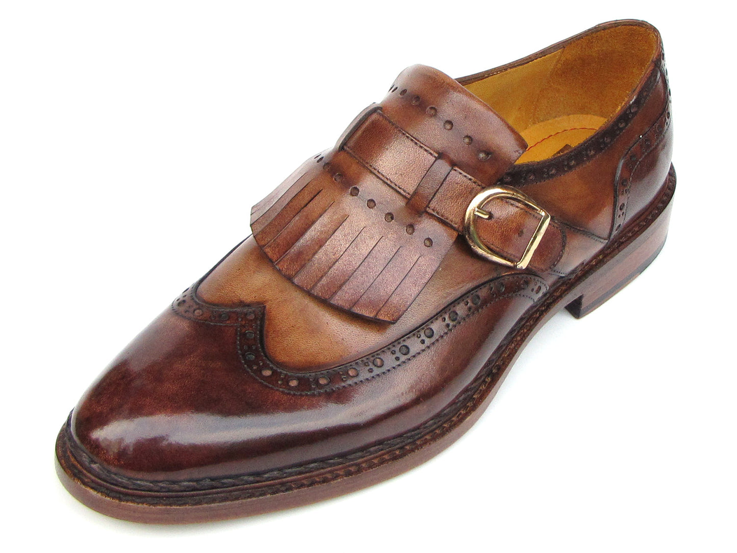 The Paul Parkman Wingtip Monkstraps Brown - 060-BRW features brown leather, decorative perforations, and a fringed kiltie detail. Handcrafted with Goodyear welted construction, this men's dress shoe is shown at a slight angle.
