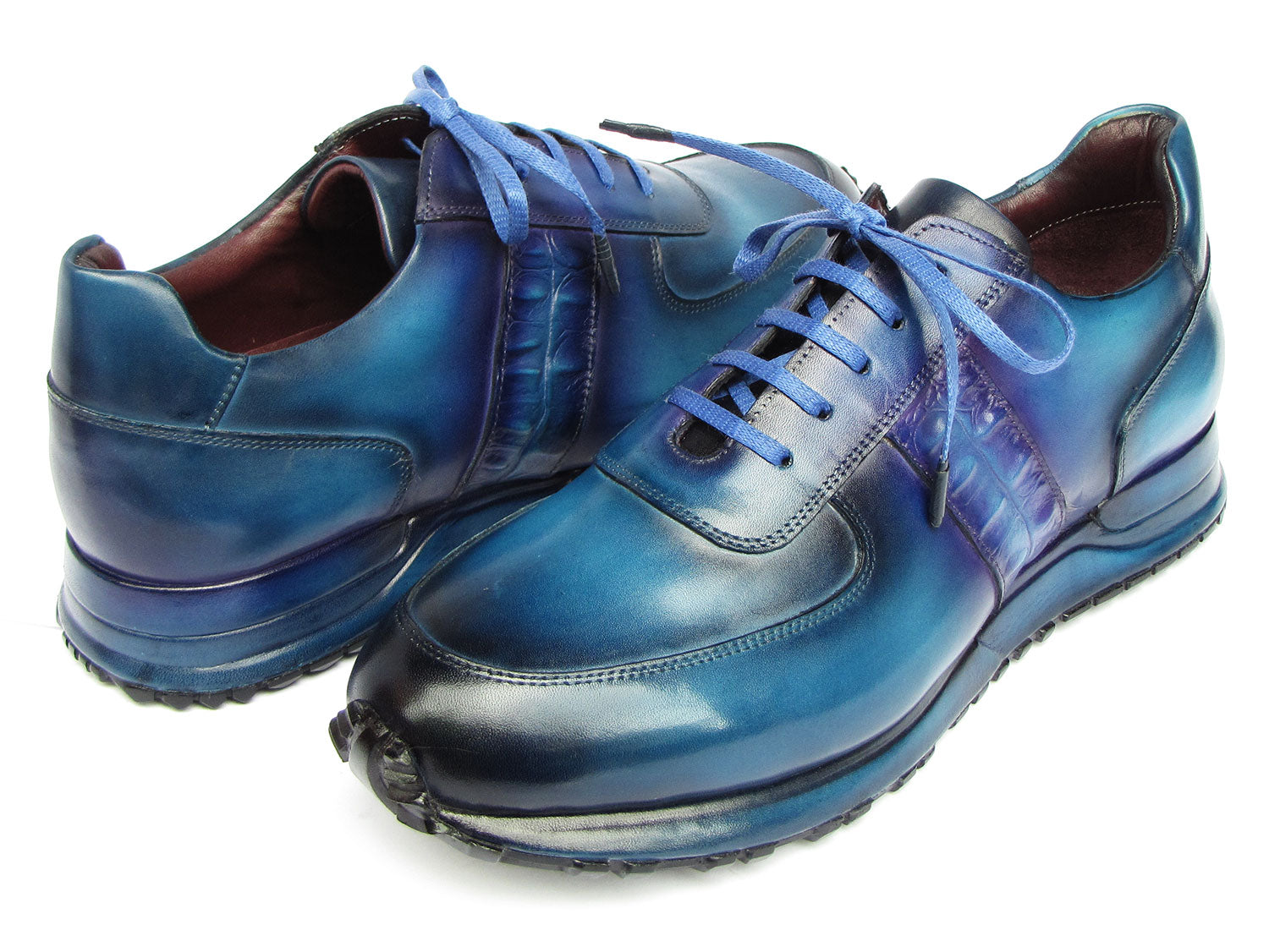 The Paul Parkman Men's Turquoise & Purple Patina Sneakers - LP207TQP showcase a striking blue gradient design, meticulously crafted from hand-painted leather and featuring laces and textured soles, delivering both style and exclusivity.