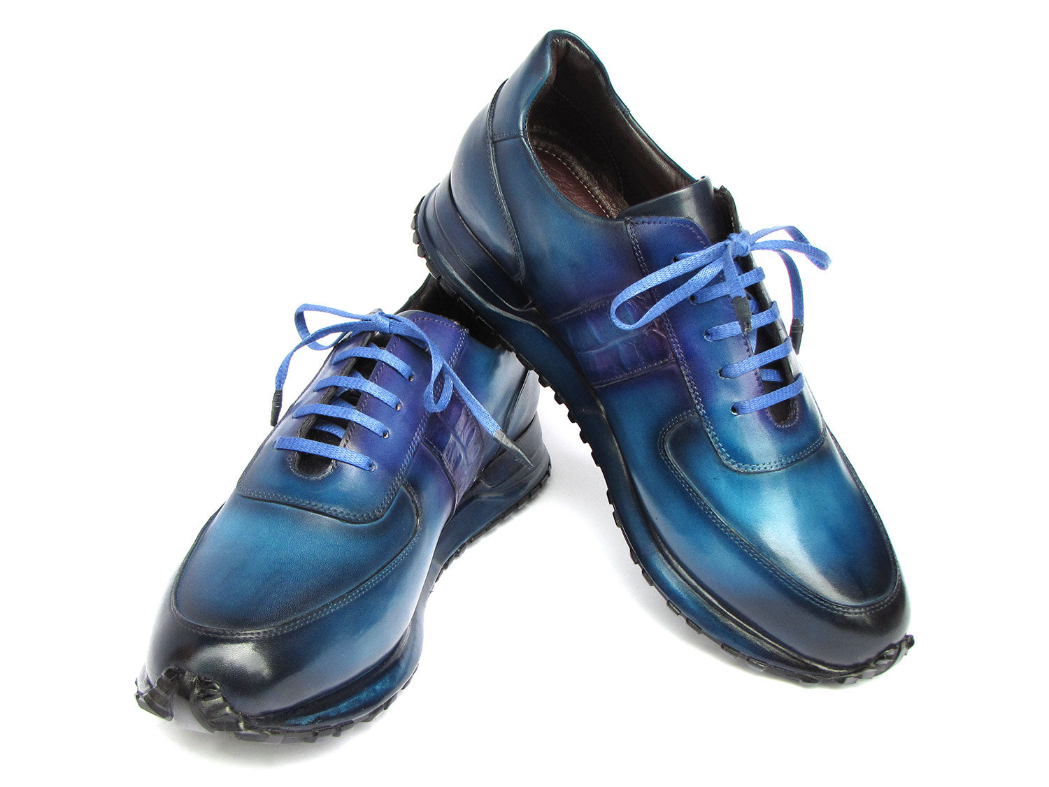 The Paul Parkman Men's Turquoise & Purple Patina Sneakers - LP207TQP showcase a striking blue gradient design, meticulously crafted from hand-painted leather and featuring laces and textured soles, delivering both style and exclusivity.
