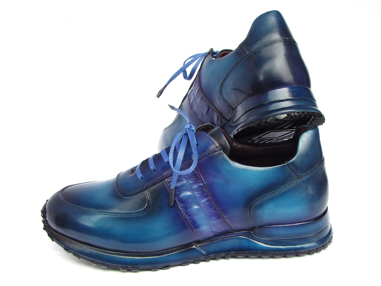 The Paul Parkman Men's Turquoise & Purple Patina Sneakers - LP207TQP showcase a striking blue gradient design, meticulously crafted from hand-painted leather and featuring laces and textured soles, delivering both style and exclusivity.