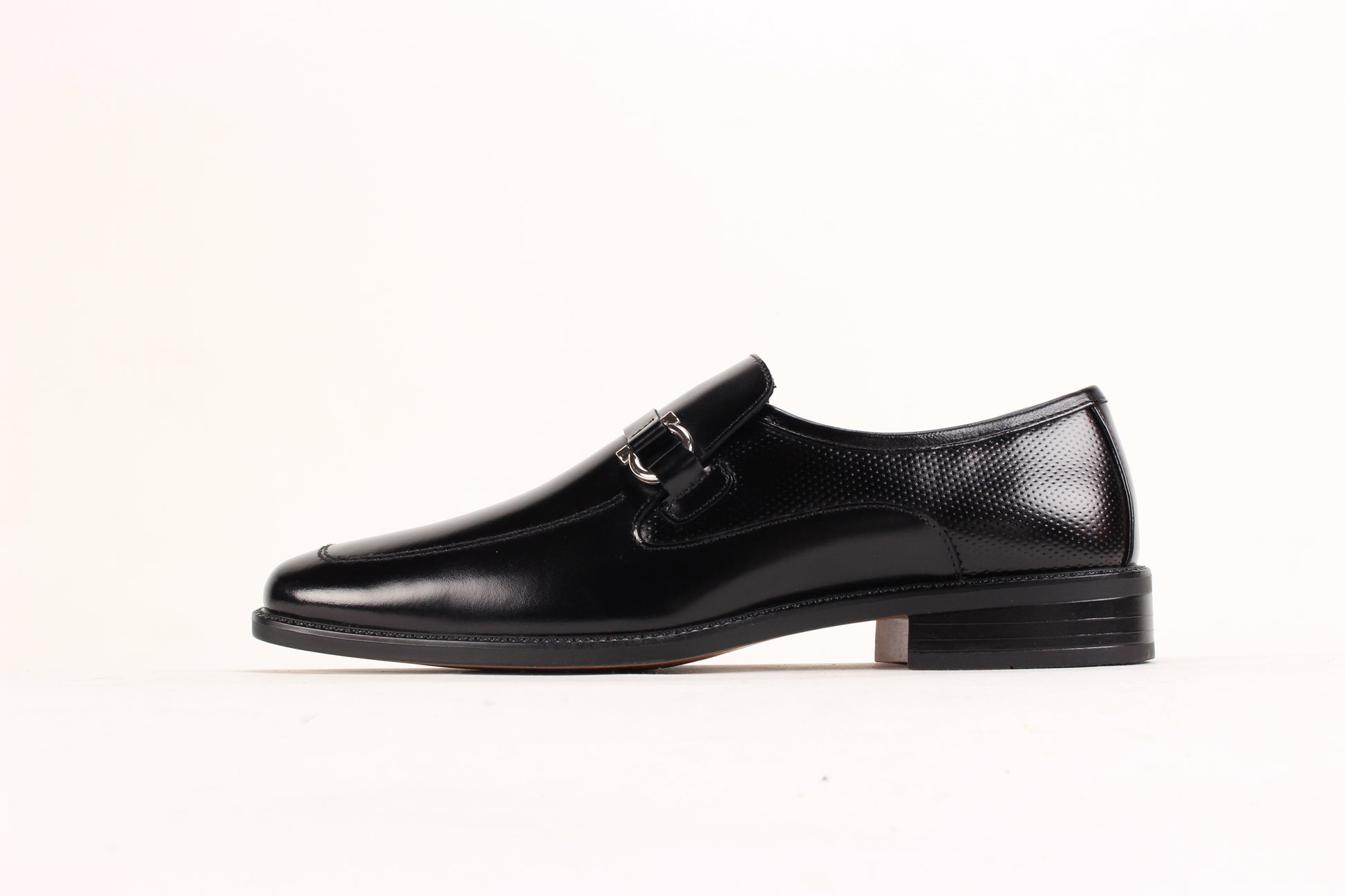The Giorgio Venturi 7061 Black Leather Shoes feature smooth black leather, a silver buckle, low heel, and square toe, displayed against a white background.