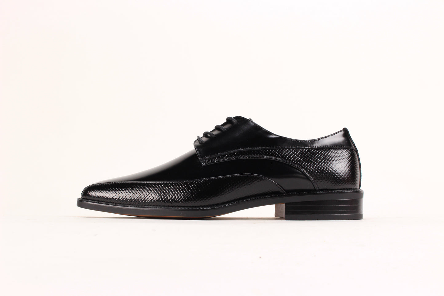 The Giorgio Venturi 7060 Black Leather Shoe features a bike toe, lace-up design, low heel, and embossed textured detailing on the sides and around the sole.