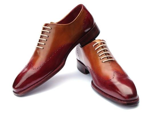 The Paul Parkman Goodyear Welted Wingtip Oxfords Bordeaux & Camel - 081-RDT feature two-tone brown and burgundy hues with brogue detailing, shown on a white background.