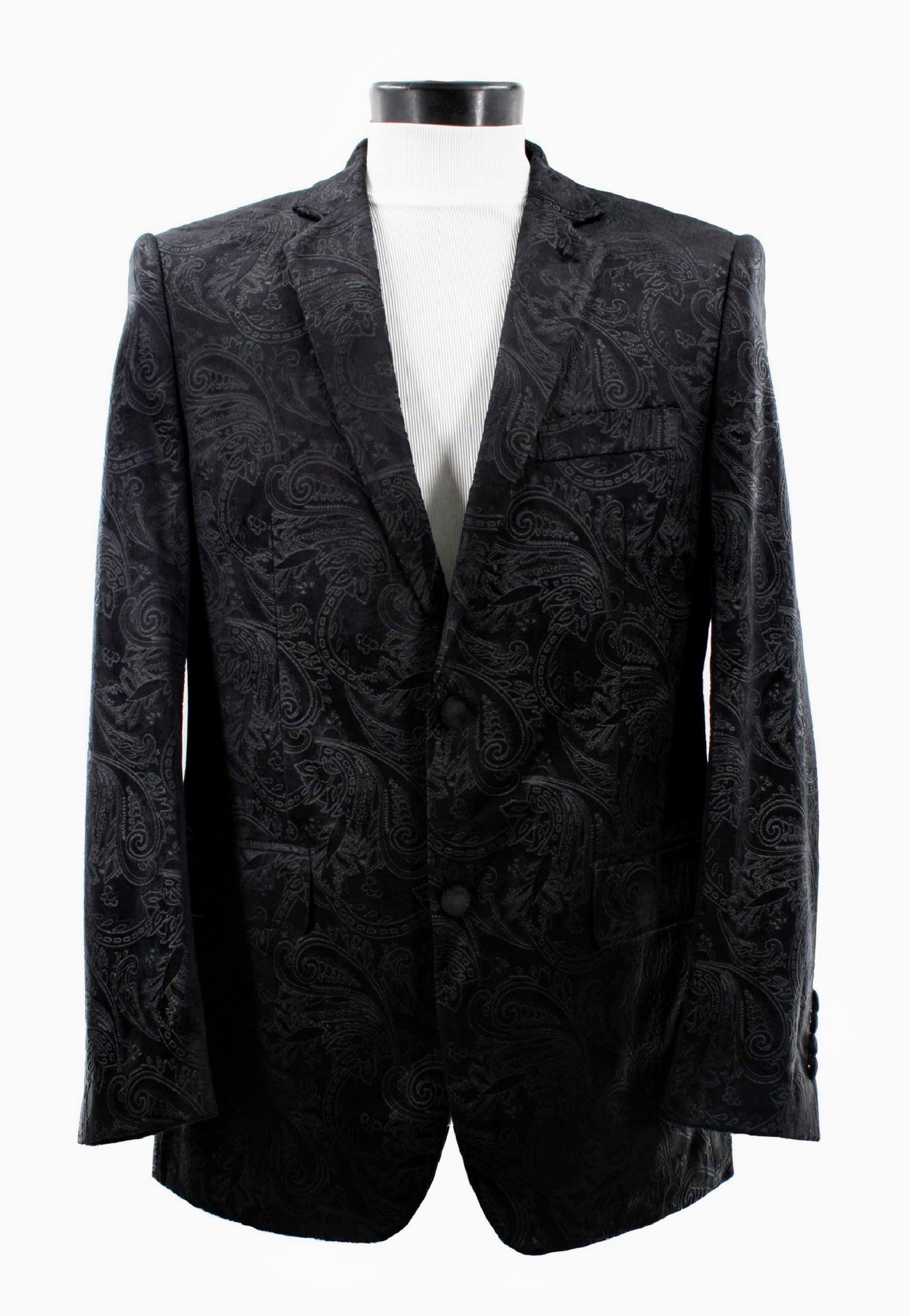 The Bassiri Blazer J1044-Black by Bassiri is displayed on a white mannequin, featuring a bold black paisley design. It elegantly complements a crisp white ribbed shirt against a plain backdrop, showcasing its timeless style.